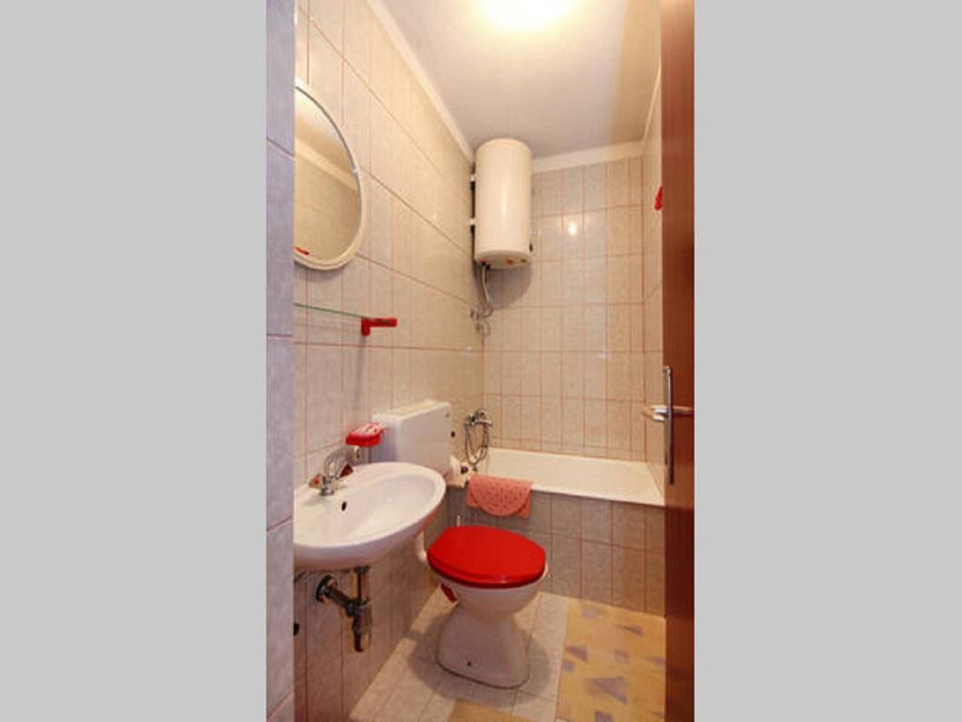 A bathroom with a sink, toilet, and bathtub.