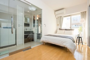 Relax in a spacious room with a large bed, walk-in closet, and bedside table.