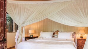 A bedroom with a canopy bed, two bedside tables with lamps, and a wooden nightstand. - Beautiful Villa With Private Pool, Bali Villa 2051 (Seminyak)