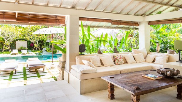 A spacious living area with a sofa, a coffee table, and a pool view. - Beautiful Villa With Private Pool, Bali Villa 2051 (Seminyak)