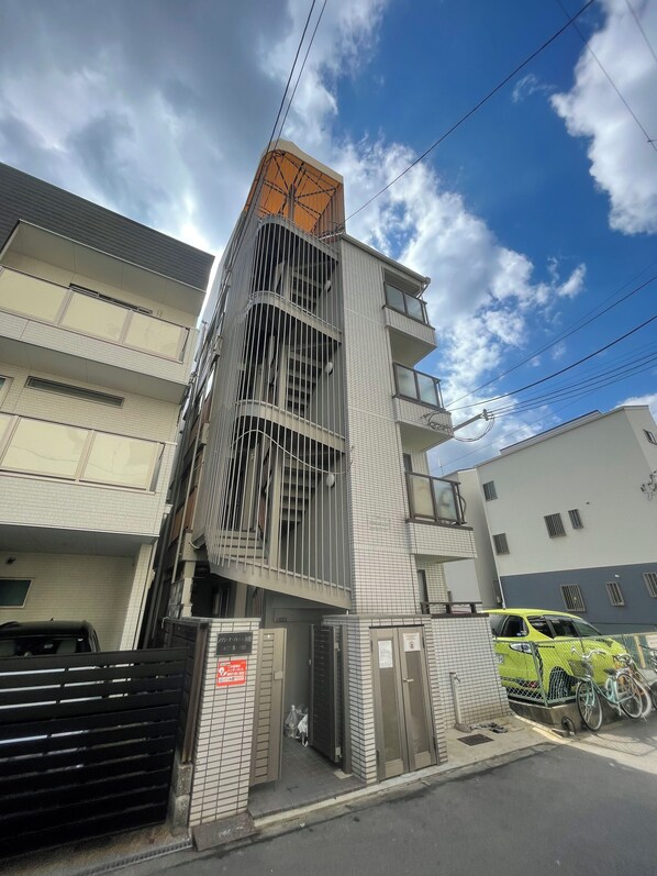 Un edificio de varios pisos con un diseño moderno, que incluye balcones y ventanas amplias.