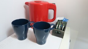 A red coffee maker, two blue mugs, and a box of Blendr coffee pods on a white countertop. - Osaka Cozy Apartment from near Metro Osaka (大阪市)
