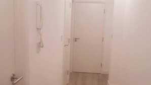 A narrow hallway with a wooden floor and white walls. - Riverside 2 (Maidstone)
