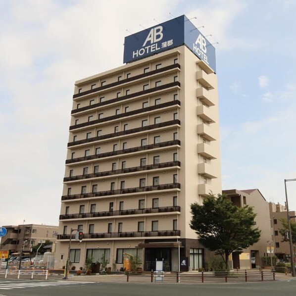 A multi-story hotel building with a prominent 'AB HOTEL' sign on the facade.