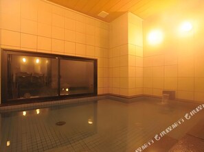 A clean, modern indoor space with a large window, tiled walls, and a reflective floor. - Ab Hotel Kamagori (Gamagori)
