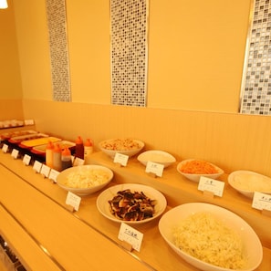 A buffet with various dishes and condiments.