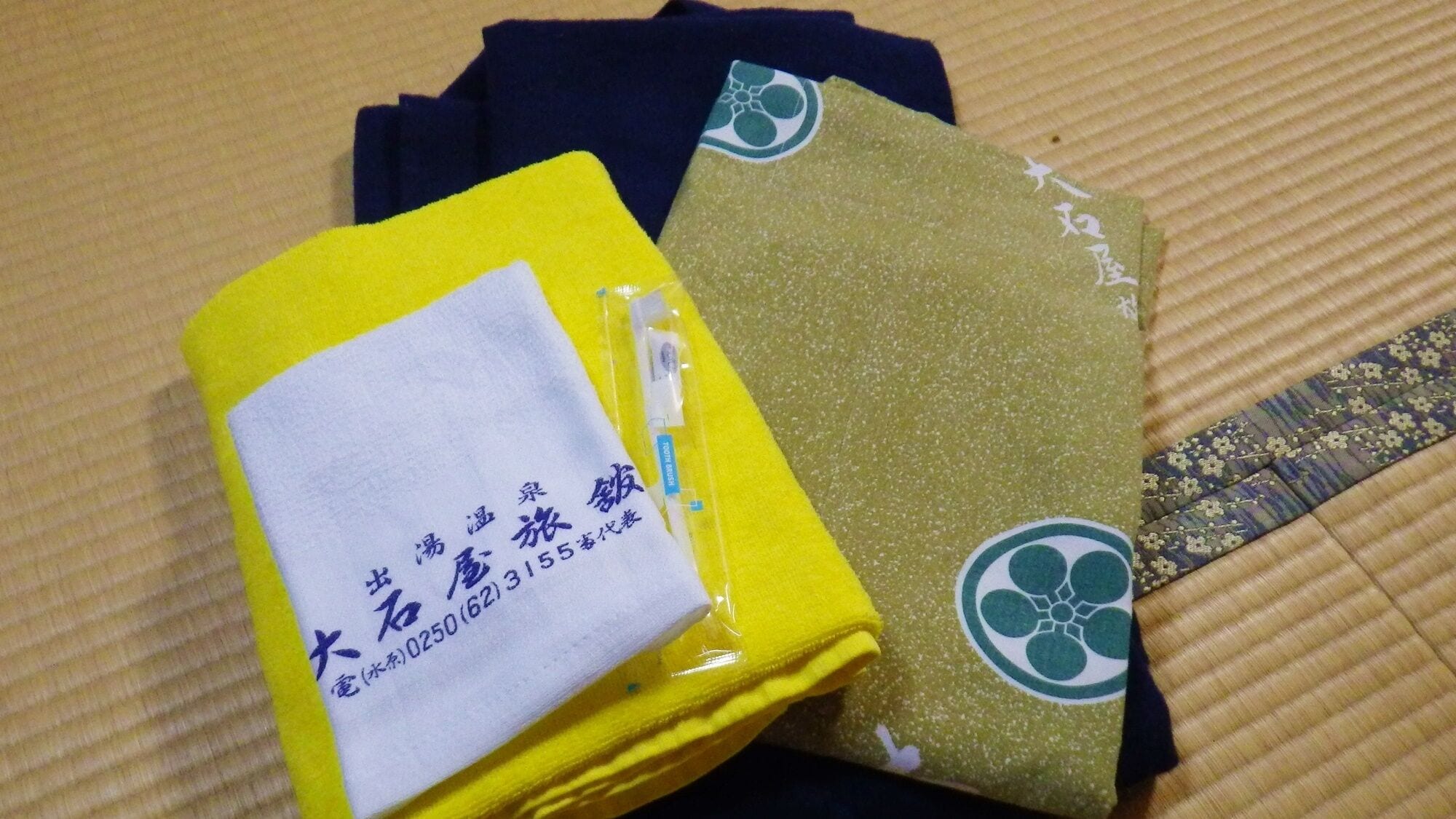 A folded item with a white label and a yellow item with a green design.