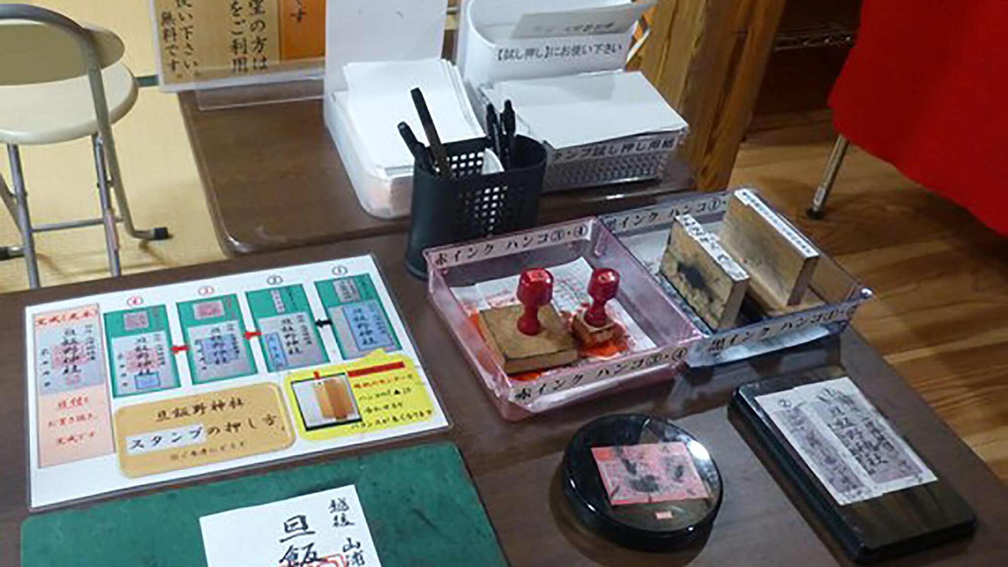 A table with various items including a menu, chopsticks, a black bowl, and a red stamp.