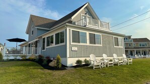 A two-story house with a balcony, a covered porch, and outdoor seating. - The Pioneer - York Beachfront living (York)