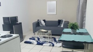 A compact living space with a kitchenette, a dining area, and a seating area. -  HEART OF SAN JUAN (Santurce)