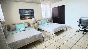 A bedroom with two beds, a desk, and a chair. -  HEART OF SAN JUAN (Santurce)