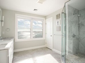 Bathtub, hair dryer, towels, toilet paper