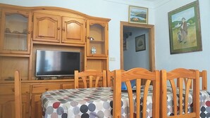 A bedroom with a bed, wooden headboard, a television, and a cabinet. - Colera House Costa Brava (Colera)