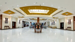 A spacious lobby with a high ceiling, recessed lighting, and a central floral arrangement. - Parrotel Lagoon Waterpark Resort (Sharm El Sheikh)