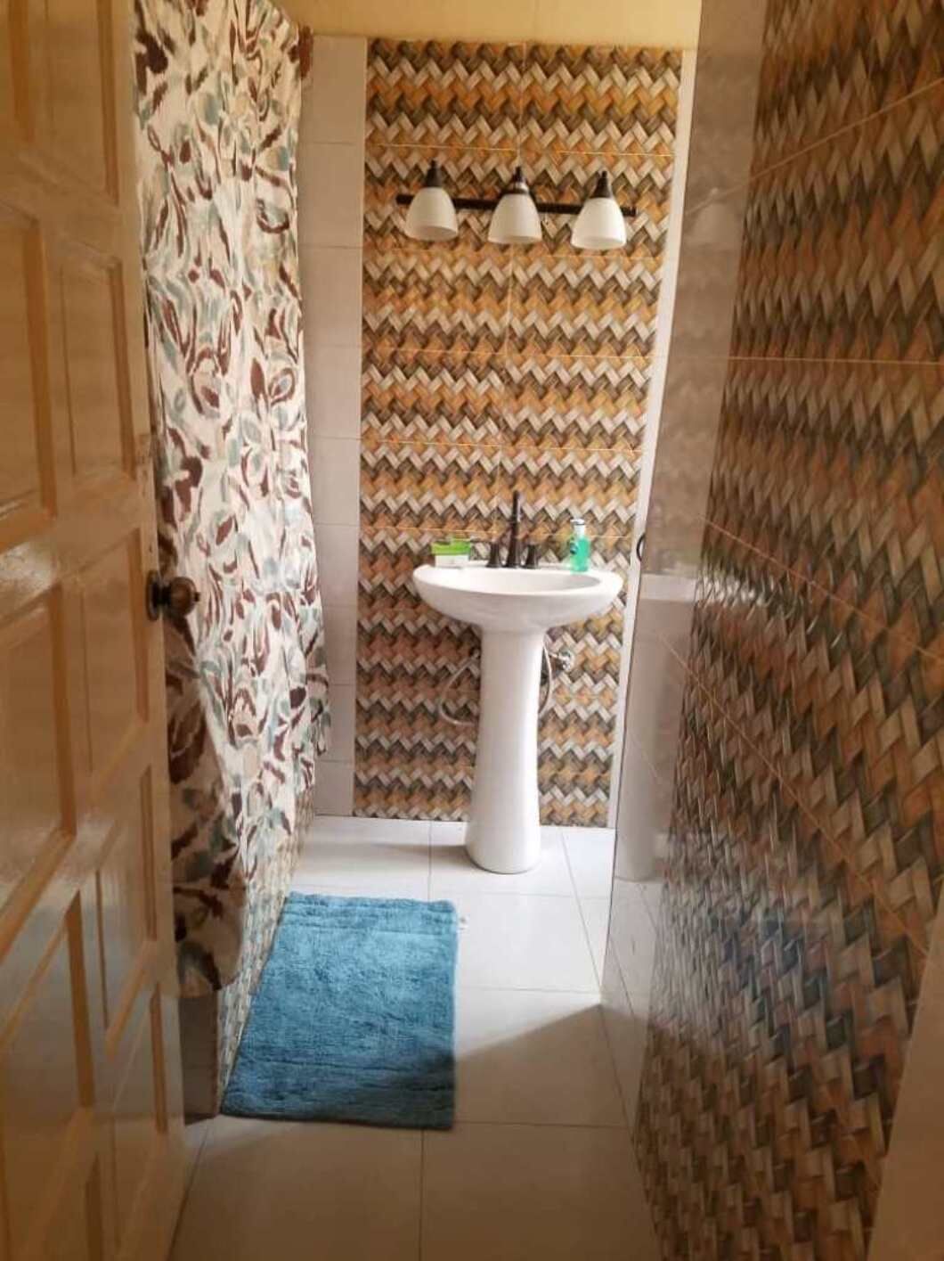 Een bad/douchecombinatie, zeep, toiletpapier