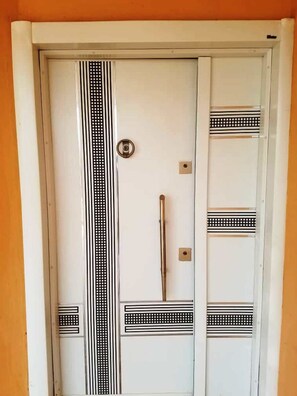 The door features a classic black and white striped pattern and a round keyhole lock.