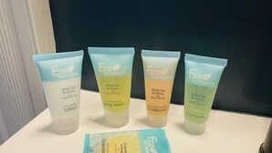 Four Eco Botanics products on a white sink: White Tea & Honey Lotion, White Tea & Honey Body Wash, White Tea & Honey Conditioner, and Nourishing Shampoo.