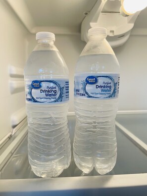 Two bottles of Great Value purified drinking water in a refrigerator. - Newly Renovated, Spacious Suite with Every Luxury (Richmond)