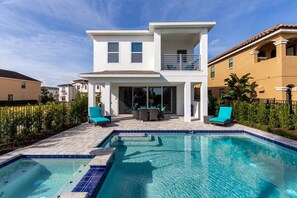 Relax on the upper-floor balcony overlooking the pool and garden.