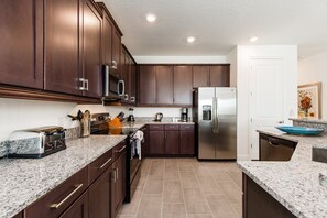 Enjoy cooking in this well-equipped kitchen with a toaster, coffee maker, and dishwasher.