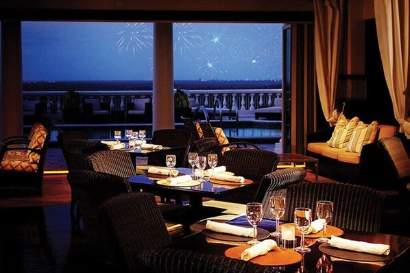 Enjoy a serene dining experience with a waterfront view from the elegantly furnished dining area.