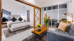 A modern bedroom with a bed, bedside table, and a large window.