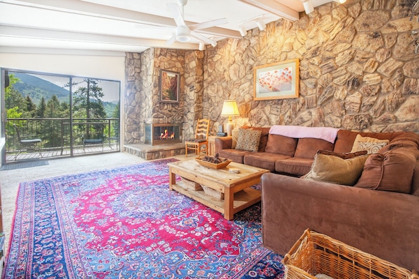 Living Room with Vaulted Ceiling and Balcony