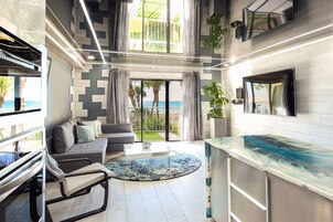 A modern living room with a sofa, coffee table, and a view of the outdoors.