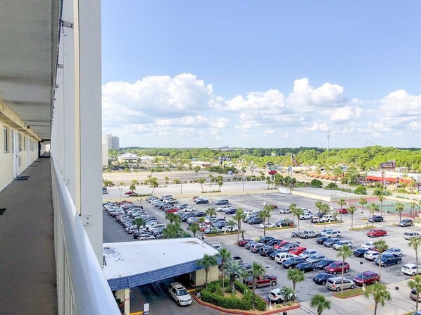 A hotel with a balcony overlooking a parking lot and a cityscape. - The Summit 105 (Panama City Beach)