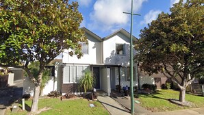 A two-story residential building with a front entrance, a satellite dish, and a mailbox. - Beautiful & Bright Studio APT (Auckland)
