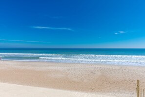 A beach with a clear sky and calm sea. - Shell Yeah - Oceanfront 4 bedroom home in Surf City! Dog Friendly! (Surf City)