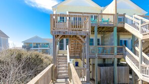 A multi-story wooden building with balconies and a staircase.