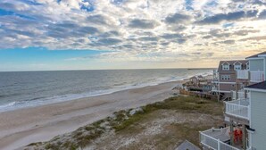 A beach view with a house overlooking the ocean. - Crab House - Oceanfront 5 BR Home with Hot Tub & Community Pool (North Topsail Beach)