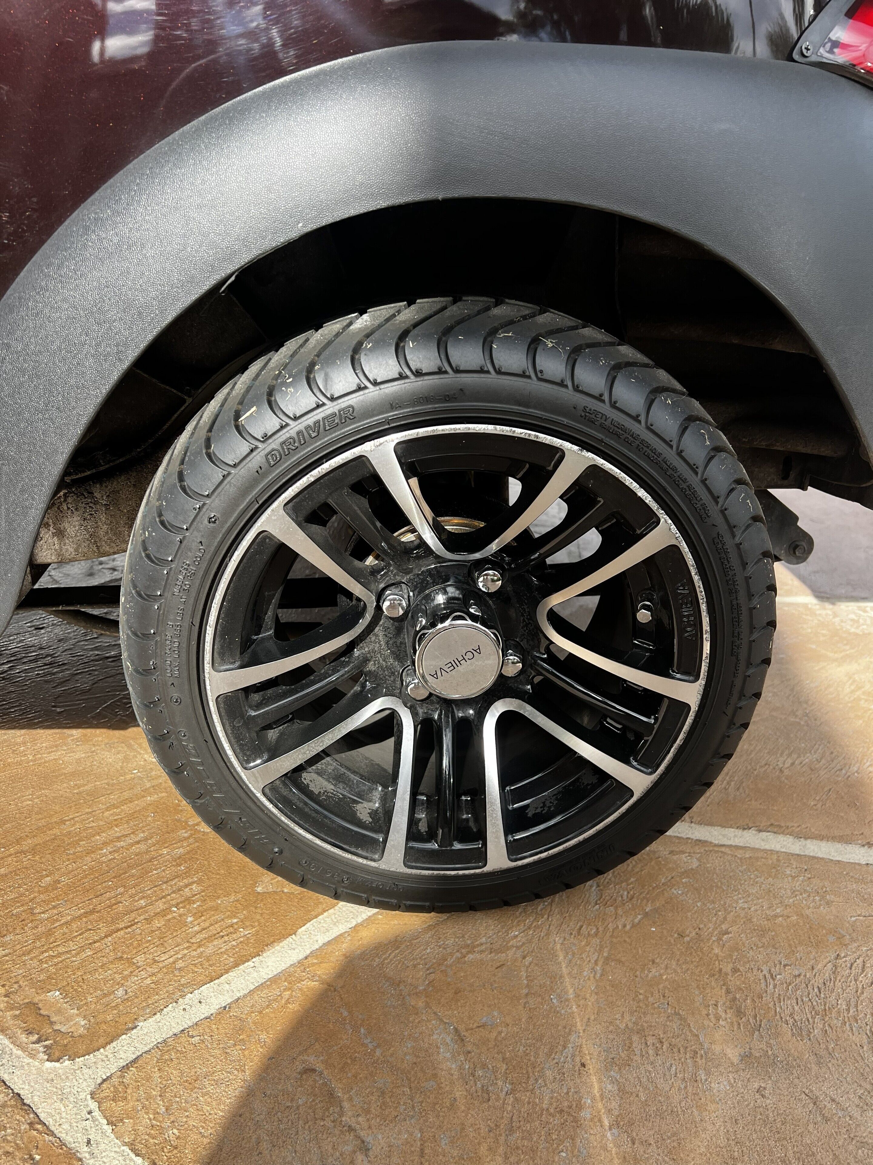 A close-up of a car's wheel and tire, with visible branding and tread pattern.