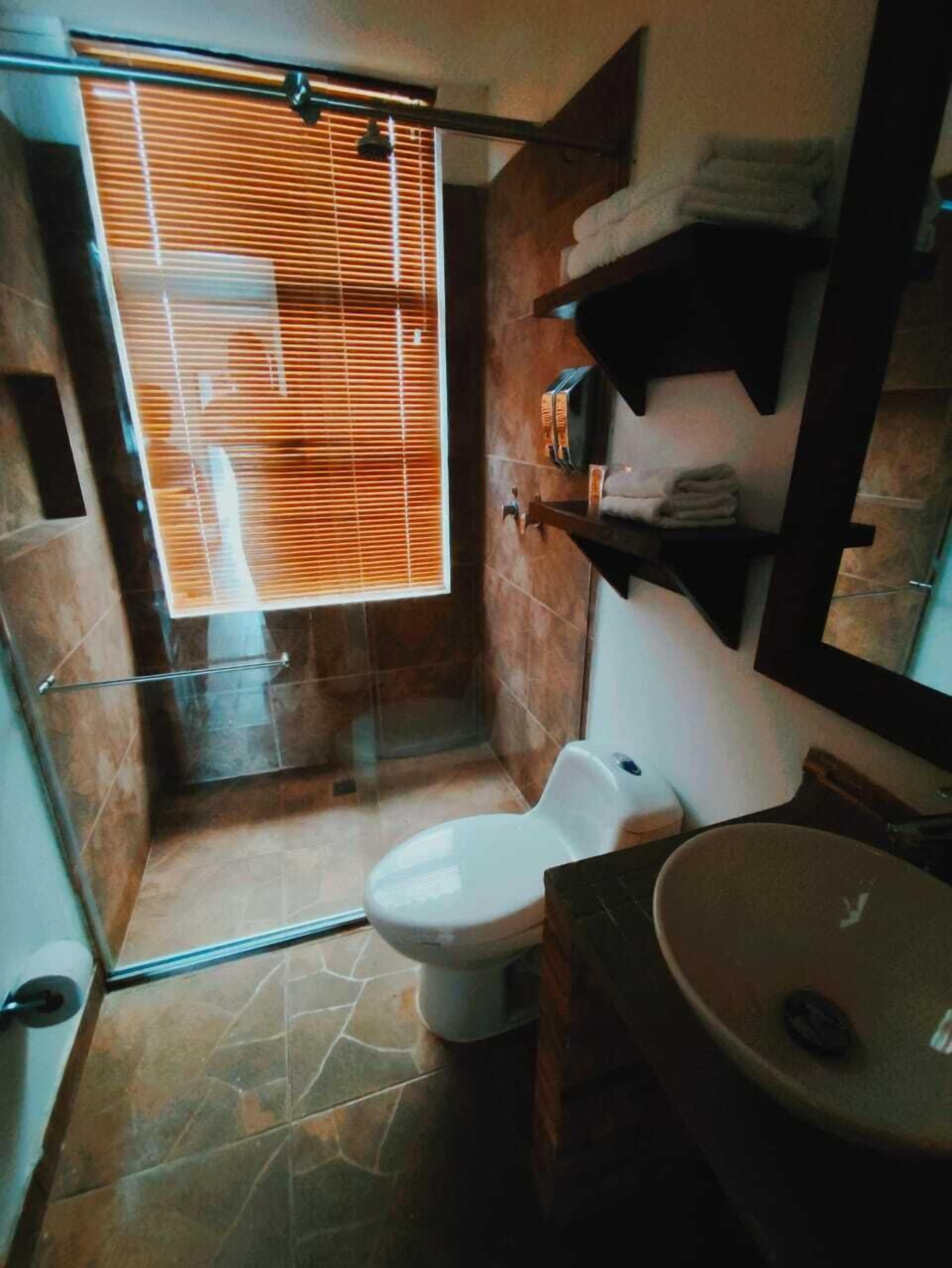 superior quadruple room | bathroom | shower, rainfall showerhead, hair dryer, towels