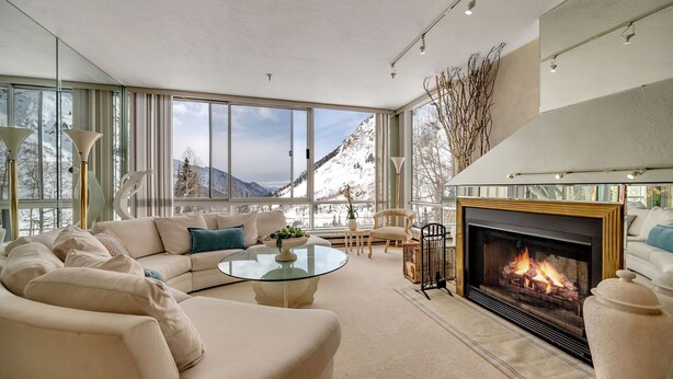 A modern living room with a fireplace, large windows, and a cozy seating area. - Comfort, Convenience, and Modern Amenities at this Ski in/Ski Out Condominium (Alta)