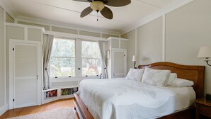 A bedroom with a wooden bed, a ceiling fan, a window with curtains, and a bookshelf. - Hawaiian Charm..Just Steps From The Ocean..On Kauai's Sunny W Side * TVNC4216 (Kekaha)