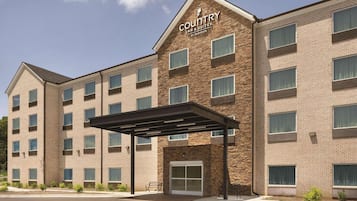 Stylish country inn with a central entrance and evenly spaced windows.