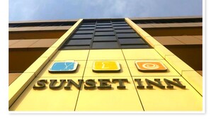 The exterior of the Sunset Inn with a clear view of the sky and the building's facade. - Sunset Inn Guest House (Monrovia)