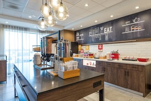 A modern kitchen with a central island, coffee machine, and various kitchen appliances. - Hampton Inn & Suites Howell (Howell)