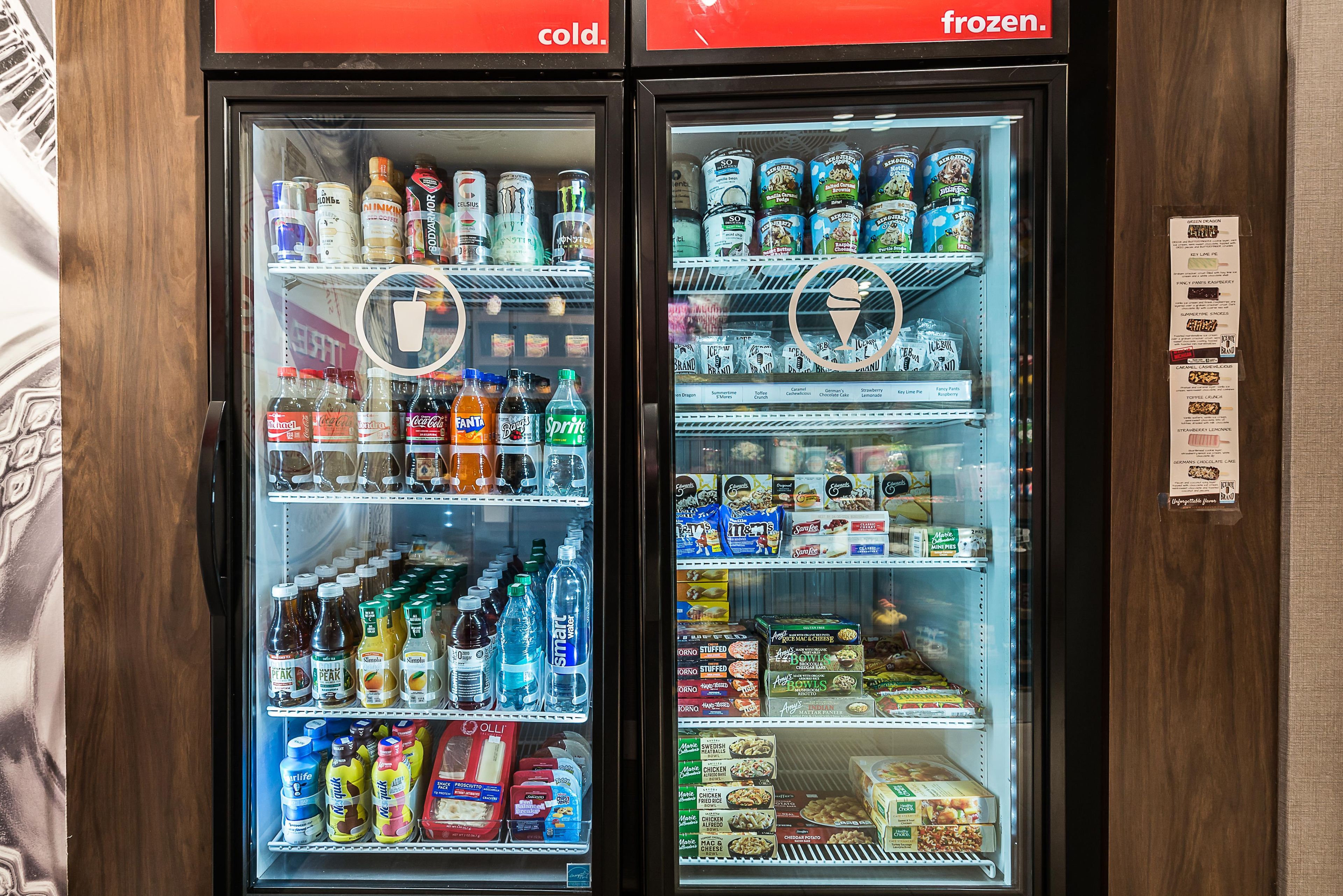 Two beverage vending machines with a variety of drinks and snacks.