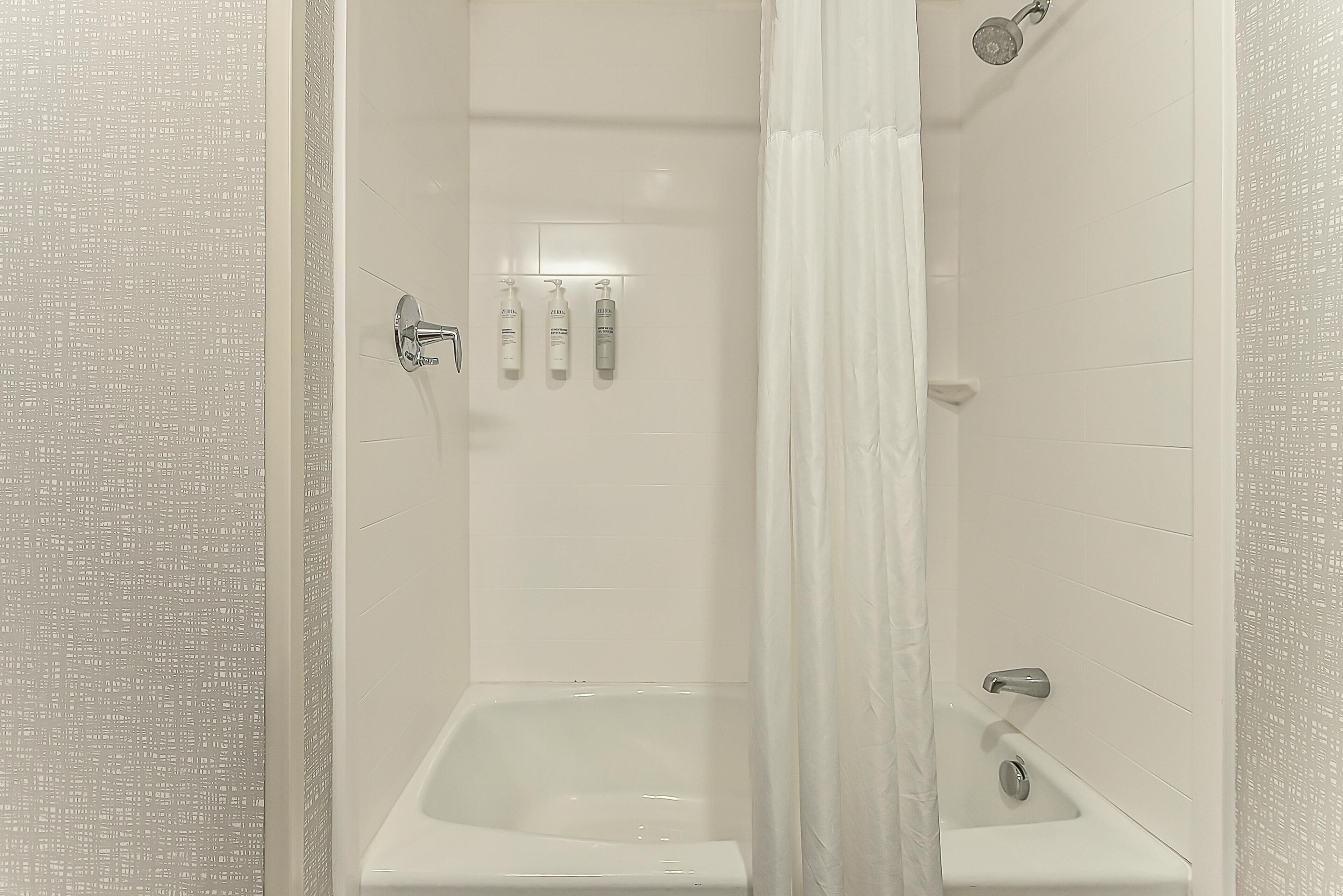 A modern bathroom with a shower, a bathtub, and a toilet.