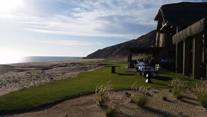 A coastal restaurant with outdoor seating overlooking the beach and ocean. - X-Mas in CABO Novaspania- AMAZING - RESORT VILLA-  PRIVATE POOL- & QUIVIRA GOLF (Cabo San Lucas,)