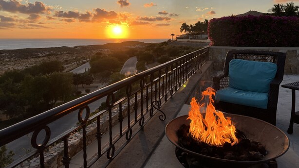A balcony with a fire pit and a view of the sunset over the sea. - X-Mas in CABO Novaspania- AMAZING - RESORT VILLA-  PRIVATE POOL- & QUIVIRA GOLF (Cabo San Lucas,)
