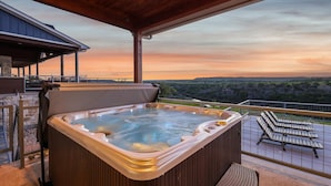 A hot tub on a balcony with a view of the landscape. - PK LakeTime: 6 Bedroom/ 4 Bath Home with Dock, pool/hot tub, and game room (Strawn)