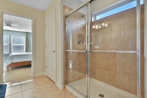 A modern bathroom with a glass shower enclosure, a bathtub, and a walk-in shower.
