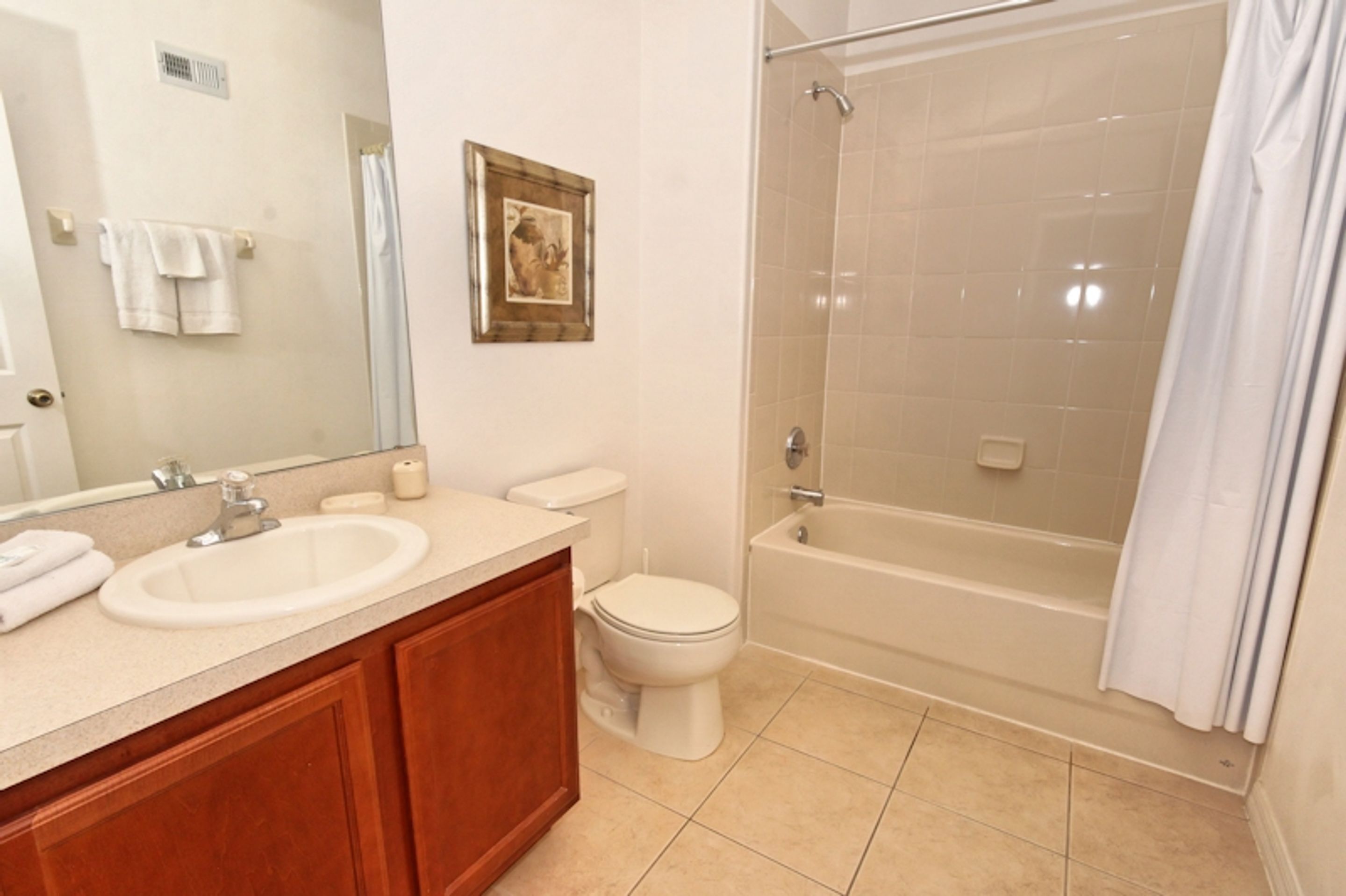 A bathroom with a sink, toilet, and bathtub.