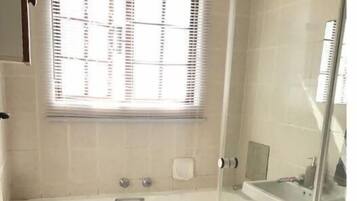 Bathtub, towels, soap, toilet paper