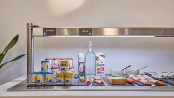 Display of dairy products and fresh ingredients showcasing the breakfast area’s inviting atmosphere.