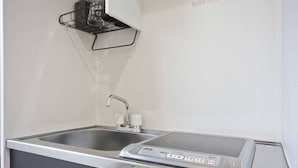 A stainless steel kitchen with a double sink, a built-in stove, and a small refrigerator. - SHITAMACHI BASE/Quiet new apt.room101/skytree view (東京)